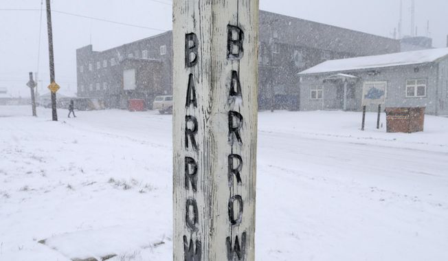 In this Oct. 10, 2014, file photo, snow falls around a sign in Barrow, Alaska. Residents in Barrow, the nation's northernmost community, have voted to change the name of their city back to its traditional Inupiaq name of Utqiagvik. (AP Photo/Gregory Bull, File)
