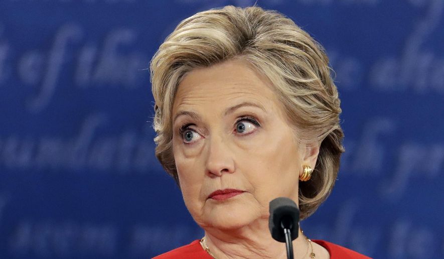 In this Sept. 26, 2016, file photo, Democratic presidential nominee Hillary Clinton listens to Republican presidential nominee Donald Trump during the U.S. presidential debate at Hofstra University in Hempstead, N.Y.  (AP Photo/Julio Cortez, File)