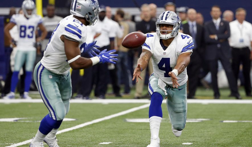FILE - In this Sept. 11, 2016, file photo, Dallas Cowboys quarterback Dak Prescott (4) pitches the ball to running back Ezekiel Elliott (21) during an NFL football game against the New York Giants in Arlington, Texas. Prescott and Elliott started the season as a Dallas novelty not seen since Roger Staubach and Calvin Hill nearly 50 years ago. Now the rookie quarterback-running back combo is setting NFL records. (AP Photo/Michael Ainsworth, File)