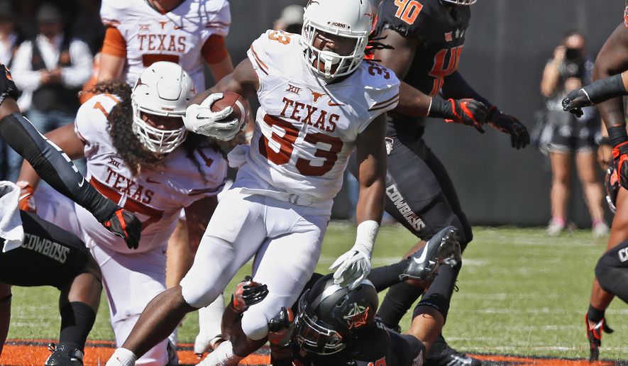 FILE - In this Oct. 1, 2016, file photo, Texas running back D'Onta Foreman (33) carries against Oklahoma State in the first half of an NCAA college football game, in Stillwater, Okla. While the Longhorns’ three-game losing skid keeps raising the pressure on coach Charlie Strong, Foreman keeps pounding away at opposing defenses and racking up some of the best rushing numbers in the country. Foreman’s 148.8 yards per game ranks second nationally and he’s averaging nearly seven yards per carry as Texas heads into a Saturday night matchup against Iowa State. (AP Photo/Sue Ogrocki, File)