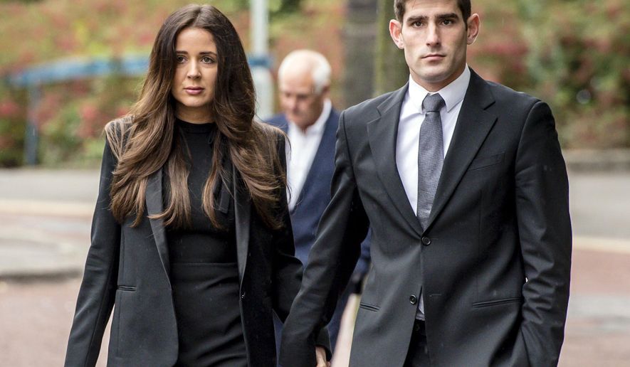 Football player Ched Evans, right, and his partner Natasha Massey arrive at Cardiff Crown Court, in Cardiff, Friday, Oct. 14, 2016, where he is on trial accused of raping a woman in 2011. A former English Premier League footballer has been found not guilty of rape following a retrial, ending a five-year fight to clear his name. (Ben Birchall/PA via AP)
