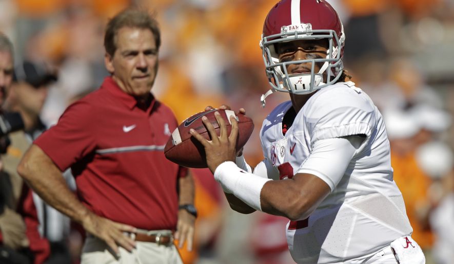 Alabama quarterback Jalen Hurts (2) warms up before an NCAA college football game against Tennessee as Alabama head coach Nick Saban watches Saturday, Oct. 15, 2016, in Knoxville, Tenn. (AP Photo/Wade Payne)