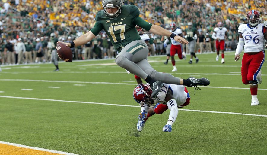 Baylor quarterback Seth Russell (17) leaps but is hit by Kansas linebacker Mike Lee (11) before entering the end zone for a touchdown after a short run in the first half of an NCAA college football game, Saturday, Oct. 15, 2016, in Waco, Texas. (AP Photo/Tony Gutierrez)