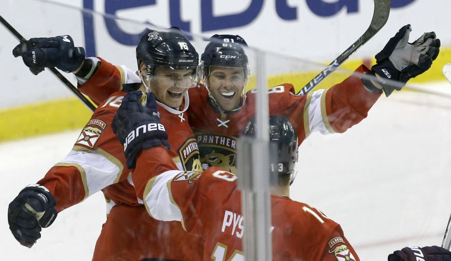Florida Panthers center Aleksander Barkov (16) is congratulated by teammates Jonathan Marchessault (81) and Mark Pysyk (13) after scoring the third goal against the Detroit Red Wings during the third period of an NHL hockey game, Saturday, Oct. 15, 2016, in Sunrise, Fla. (AP Photo/Alan Diaz)