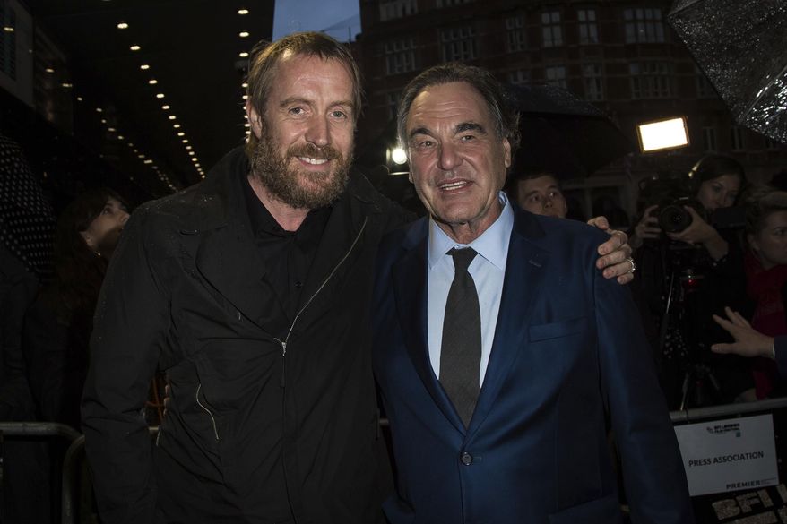 Actor Rhys Ifans and director Oliver Stone, right, pose for photographers upon arrival at the premiere of the film 'Snowden', showing as part of the London Film Festival in London, Saturday, Oct. 15, 2016. (Photo by Vianney Le Caer/Invision/AP)