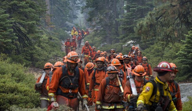 CORRECTS LOCATION OF FIRE SOUTH LAKE TAHOE, CALIFORNIA - Hand crews finish up work on the Emerald Fire along Highway 89, Friday, Oct. 14, 2016 on the southwest shores of Lake Tahoe. The blaze that burned about 200 acres northwest of South Lake Tahoe, California was one of three wind-whipped wildfires burning along the Sierra Nevada. The largest one destroyed more than 20 homes in a rural valley between Carson City and Reno, Nevada. (Randall Benton/The Sacramento Bee via AP)