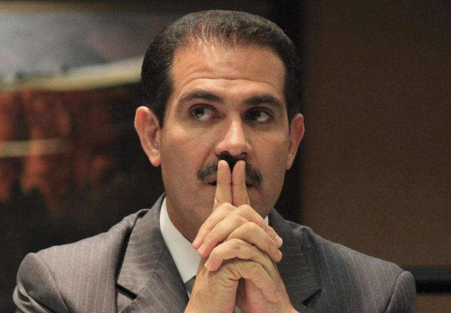 FILE - In this Oct. 5, 2012 file photo, Sonora Gov. Guillermo Padres Elias of Mexico waits for the start of a news conference following the 30th annual Border Governors Conference in Albuquerque, N.M. Mexican officials said on Saturday, Oct. 15, 2016 the international police agency Interpol has issued a red notice for the detention of the former Mexican governor who is under investigation on allegations of corruption. (AP Photo/Susan Montoya Bryan, File)