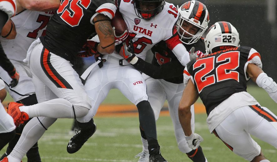 Utah's Cory Butler-Boyd (16) tries to push past Oregon State's Caleb Saulo (35) and Xavier Crawford (12) during the first half of an NCAA college football game in Corvallis, Ore., on Saturday, Oct. 15, 2016. (AP Photo/Timothy J. Gonzalez)