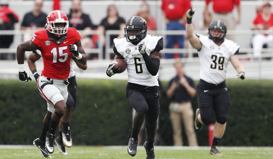 Vanderbilt's Darrius Sims (6) tries to out run Georgia's D'Andre Walker (15) as he returns the opening kickoff in the first half of an NCAA college football game Saturday, Oct. 15, 2016, in Athens, Ga. Walker's return setup a touchdown. (AP Photo/John Bazemore)
