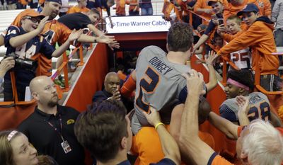 Syracuse quarterback Eric Dungey (2) is carried off the field after his team's 31-17 win over Virginia Tech in an NCAA college football game on Saturday, Oct. 15, 2016, in Syracuse, N.Y. (AP Photo/Mike Groll)