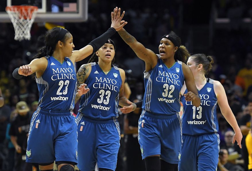 Members of the Minnesota Lynx, from left, Maya Moore, Seimone Augustus, Rebekkah Brunson and Lindsay Whalen celebrate during the second half in Game 4 of the WNBA Finals against the Los Angeles Sparks, Sunday, Oct. 16, 2016, in Los Angeles. The Lynx won 85-79. (AP Photo/Mark J. Terrill)