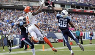 Cleveland Browns wide receiver Terrelle Pryor (11) catches a 7-yard touchdown pass as he is defended by Tennessee Titans cornerback Brice McCain (23) safety Rashad Johnson (25) in the first half of an NFL football game Sunday, Oct. 16, 2016, in Nashville, Tenn. (AP Photo/James Kenney)