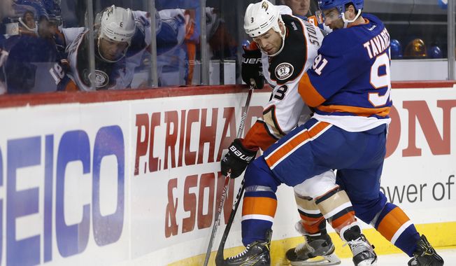 CORRECTS TO SECOND PERIOD NOT FIRST New York Islanders center John Tavares (91) pins Anaheim Ducks defenseman Clayton Stoner (3) against the boards during the second period of an NHL hockey game, Sunday, Oct. 16, 2016, in New York. (AP Photo/Kathy Willens)
