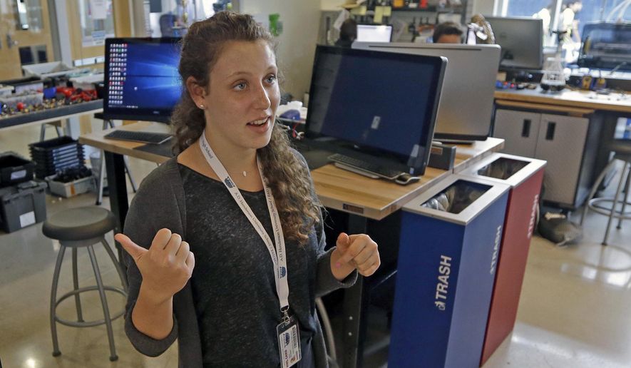In this photo taken Wednesday, Sept. 7, 2016, Aya Tal-mason gestures as she talks to a reporter, at Florida Atlantic University High School, in Boca Raton, Fla. Tal-mason described her research on cancer-fighting drugs. At tuition-free Florida Atlantic University High School, all students can simultaneously earn their high school diploma and bachelor’s degree. (AP Photo/Alan Diaz)