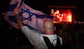 Activist Paul Antey holds up an Israeli flag during Roger Waters&#39; concert at Desert Trip Sunday.  (Mark Ralston/AFP)