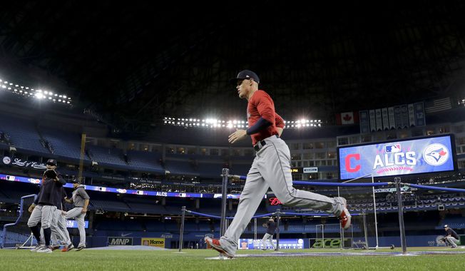 Members of the Cleveland Indians warm up before Game 3 of baseball&#x27;s American League Championship Series against the Toronto Blue Jays in Toronto, Monday, Oct. 17, 2016. (AP Photo/Charlie Riedel)