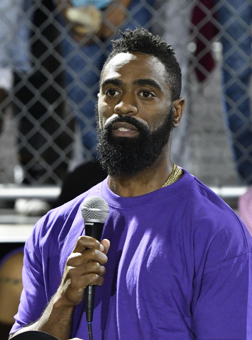 Former Olympian Tyson Gay speaks to the mourners gathered in memory of his daughter Trinity at Lafayette High School, Monday, Oct. 17, 2016, in Lexington, Ky. Several thousand people, including Tyson Gay, turned out Monday night for a candlelight vigil in Kentucky to honor Gay's 15-year-old daughter, who was fatally shot over the weekend. (AP Photo/Timothy D. Easley)