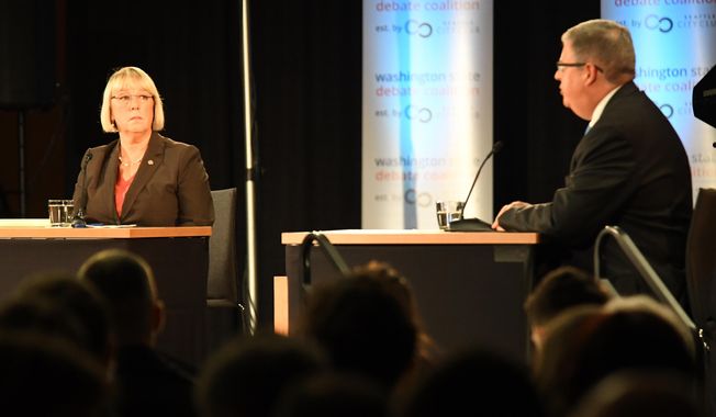 Senator Patty Murray, left, listens to challenger Chris Vance, right, make a point during their debate Sunday, Oct. 16, 2016 at Gonzaga University, in Spokane, Wash.  (Jesse Tinsley/The Spokesman-Review via AP)