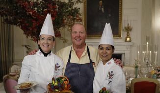 From left, White House Executive Pastry Chef Susan Morrison, American chef Mario Batali, and White House Executive Chef Cris Comerford pose for photographers during a preview in advance of the State Dinner in honor of the Official Visit of Italian Prime Minister Matteo Renzi and his wife Agnese Landini, Monday, Oct. 17, 2016, in the State Dining Room of the White House in Washington. (AP Photo/Carolyn Kaster)