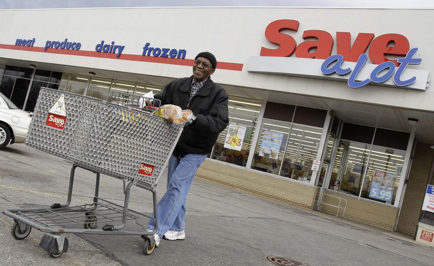 FILE - In this April 12, 2011 file photo, shopper Andrew Boston leaves the Save-a-Lot grocery store with his purchases in Northfield, Ohio. Supervalu said Monday, Oct. 17, 2016 that it is selling its Save-A-Lot supermarket chain for $1.37 billion to Canadian private equity firm Onex Corp. The deal is expected to close before the end of January. (AP Photo/Amy Sancetta, File)