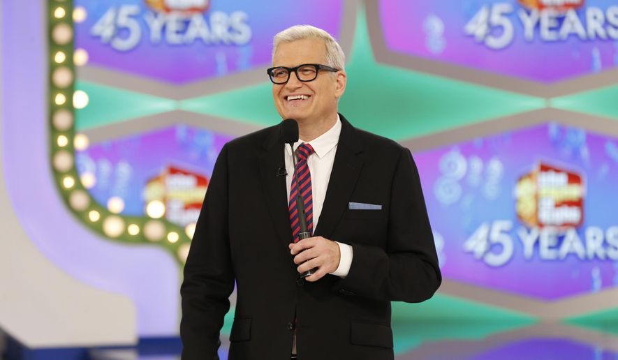 In this image released by CBS, host Drew Carey appears on the set of "The Price is Right." On the episode airing Monday, Oct. 17, 2016, a trio of contestants spun $1 on the game show's famous wheel. The three contestants each landed on different combinations of $1 in a pair of spins during one of the show's showcase showdowns. Carey pumped his fist in the air after the contestants achieved the first three-way tie in the show's history. (Monty Brinton/CBS via AP)