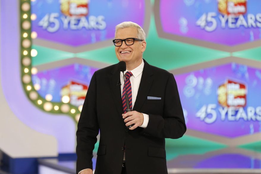 In this image released by CBS, host Drew Carey appears on the set of "The Price is Right." On the episode airing Monday, Oct. 17, 2016, a trio of contestants spun $1 on the game show's famous wheel. The three contestants each landed on different combinations of $1 in a pair of spins during one of the show's showcase showdowns. Carey pumped his fist in the air after the contestants achieved the first three-way tie in the show's history. (Monty Brinton/CBS via AP)