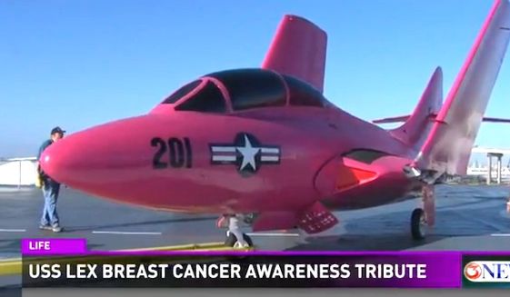 A hot pink F9F-8 Cougar is featured at the USS Lexington Museum in Corpus Christi, Texas, for breast cancer awareness month. (WXIA-TV 11 Alive NBC screenshot)