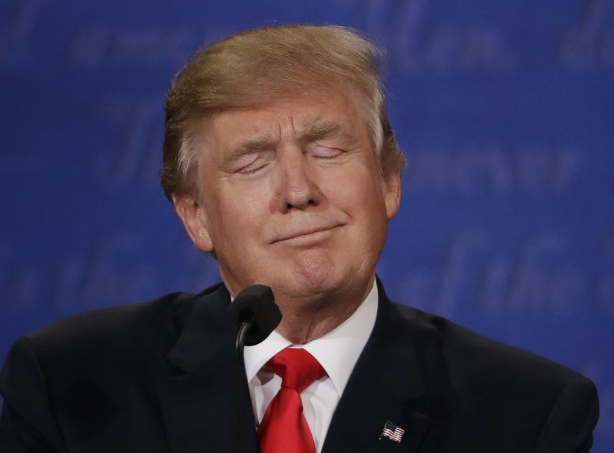 Republican presidential nominee Donald Trump listens to Democratic presidential nominee Hillary Clinton during the third presidential debate at UNLV in Las Vegas, Wednesday, Oct. 19, 2016. (AP Photo/David Goldman)
