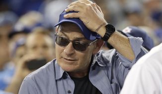 Actor Charlie Sheen reacts during the fifth inning of Game 4 of the National League baseball championship series between the Chicago Cubs and the Los Angeles Dodgers Wednesday, Oct. 19, 2016, in Los Angeles. (AP Photo/David J. Phillip)