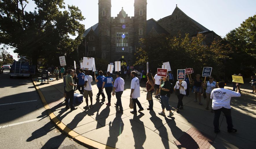 Faculty and their supporters demonstrate at West Chester University in West Chester, Pa., Wednesday, Oct. 19, 2016. Faculty at Pennsylvania state universities went on strike Wednesday morning, disrupting classes midsemester after contract negotiations hit an impasse. (AP Photo/Matt Rourke)