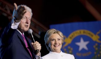 Former President Bill Clinton, left, accompanied by Democratic presidential candidate Hillary Clinton, right, speaks at debate watch party at the Craig Ranch Regional Amphitheater in North Las Vegas, Wednesday, Oct. 19, 2016, following the third presidential debate. (AP Photo/Andrew Harnik)