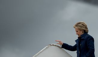 Democratic presidential candidate Hillary Clinton arrives at Cleveland Burke Lakefront Airport in Cleveland, Friday, Oct. 21, 2016, to attend a rally. (AP Photo/Andrew Harnik)