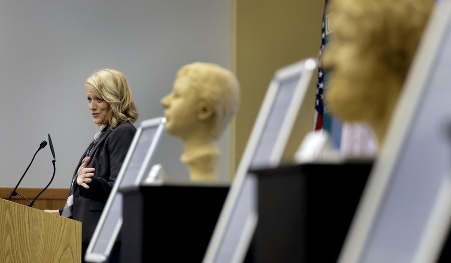 Dr. Erin Kimmerle, associate professor n the Department of Anthropology at the University of South Florida, gestures as she speaks to the members of the Art of Forensics conference Friday, Oct. 21, 2016, in Tampa, Fla. Kimmerle, and several forensic artists, have been working with law enforcement officials on cold cases in Florida to help give victims a face in hopes family members may recognize them. (AP Photo/Chris O'Meara)