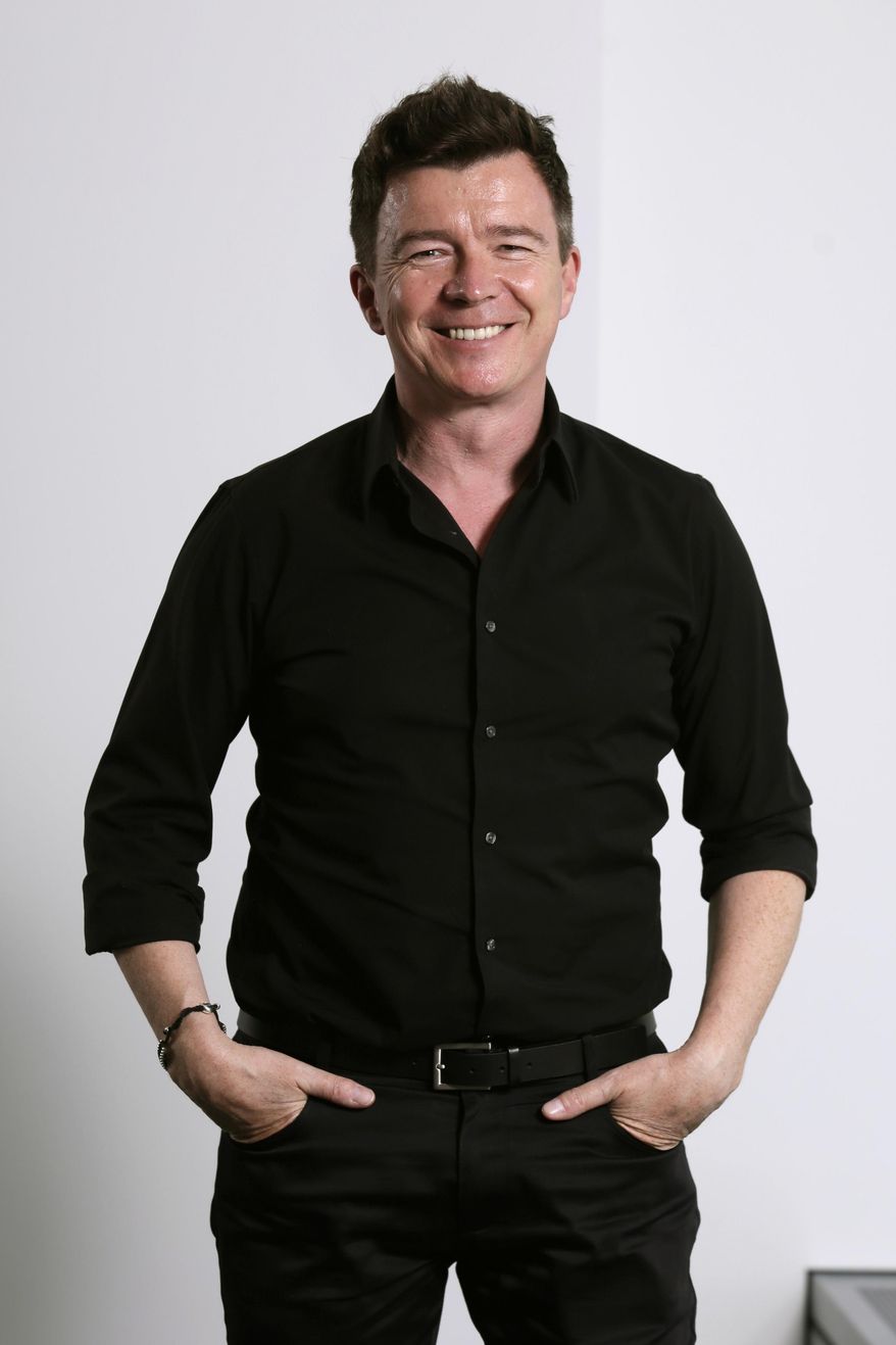 In this Aug. 9, 2016 photo, singer Rick Astley poses for photos in New York to promote his first album of new music in 23 years. (AP Photo/Richard Drew)