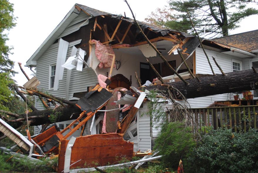 A large tree lays fallen on a house after high winds and heavy rain hit the area and neighborhood, south of Lock Haven, in Clinton County, Pa., Friday, Oct. 21, 2016. Home owner Frank Dwyer, a well known retired school teacher and former principal, died in the incident. A series of storms hopscotched across western and central Pennsylvania overnight, turning roads into rivers, closing schools and damaging homes in communities as far as 150 miles apart. (Lana Muthler/The Express via AP)