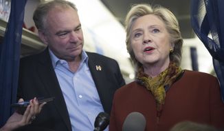 Democratic presidential candidate Hillary Clinton and Democratic vice presidential candidate Sen. Tim Kaine, D-Va. speak to reporters on board the campaign airplane in this Saturday, Oct. 22, 2016 photo from Pittsburgh, Pa. (AP Photo/Mary Altaffer) **FILE*