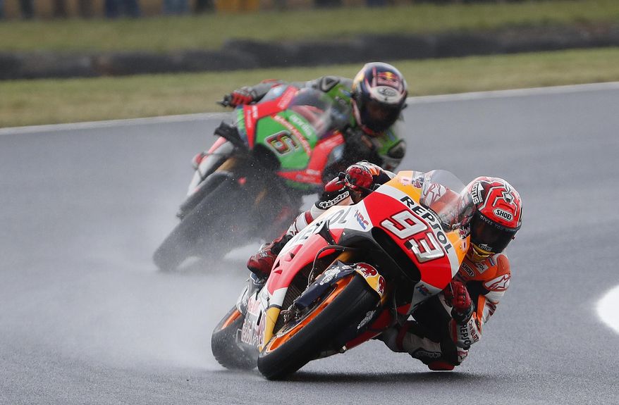 Honda MotoGP rider Marc Marquez of Spain leads Aprilia Racing Team Gresini MotoGP rider Stefan Bradl of Germany during the qualifying session for the Australian Motorcycle Grand Prix in Phillip Island, Australia, Saturday, Oct. 22, 2016. (AP Photo/Glenn Nicholls)