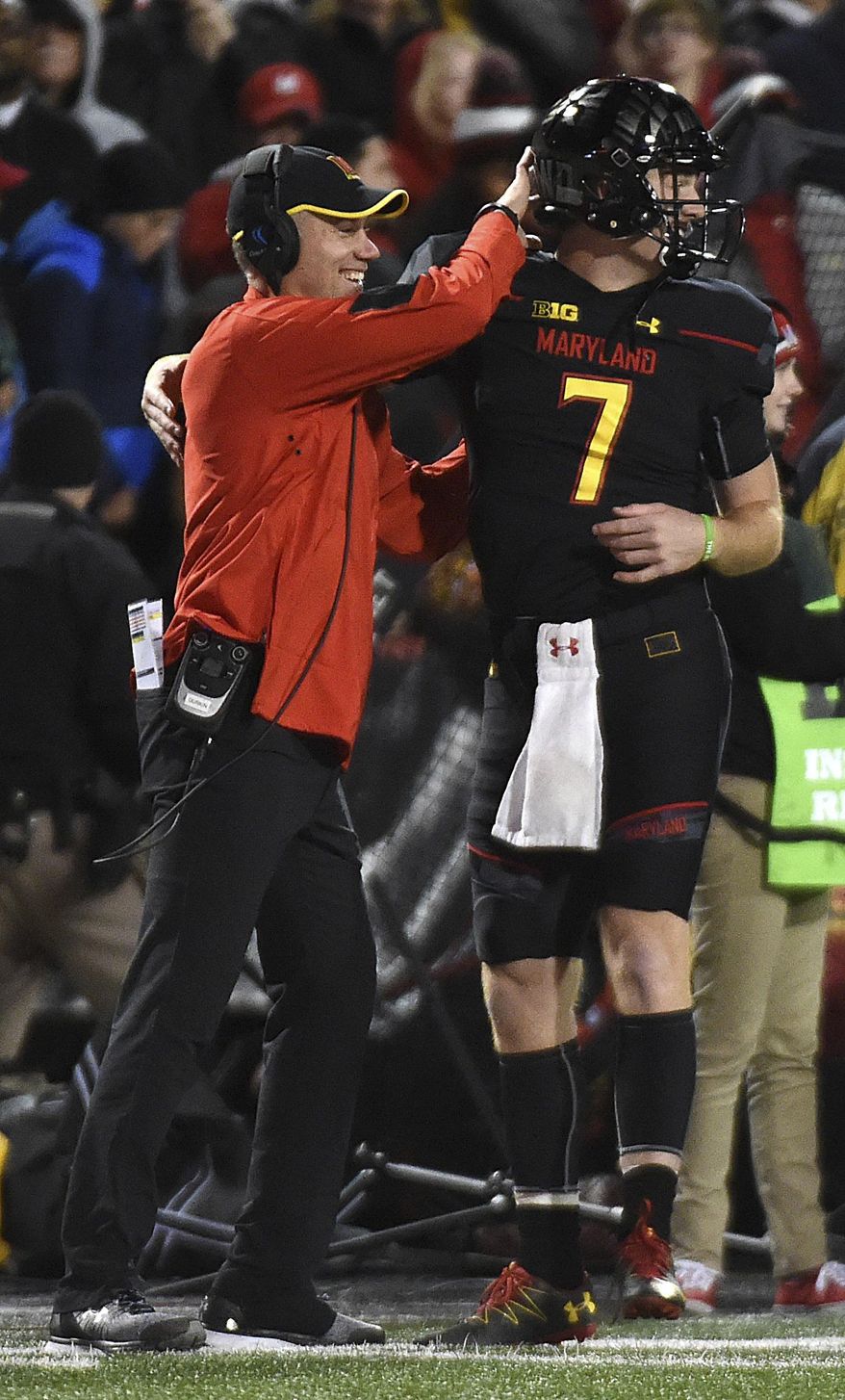 Maryland head coach DJ Durkin and quarterback Caleb Rowe celebrate a touchdown against Michigan State in the first half of an NCAA college football game, Saturday, Oct. 22, 2016, in College Park, Md. (AP Photo/Gail Burton)