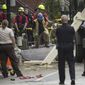 This photo provided by WBUR.ORG shows emergency personnel at the scene of a water main break, Friday, Oct. 21, 2016 in Boston.  Two workers in Boston were killed when a water main gave way and flooded a deep trench where they were working. The Boston Fire Department recovered the bodies Friday night in the South End neighborhood after several hours of painstaking work.  (Jesse Costa/WBUR.ORG via AP)