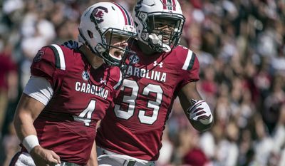 South Carolina starting quarterback Jake Bentley (4) and South Carolina running back David Williams (33) celebrate a touchdown during the first half of an NCAA college football game Saturday, Oct. 22, 2016, in Columbia, S.C. (AP Photo/Sean Rayford)