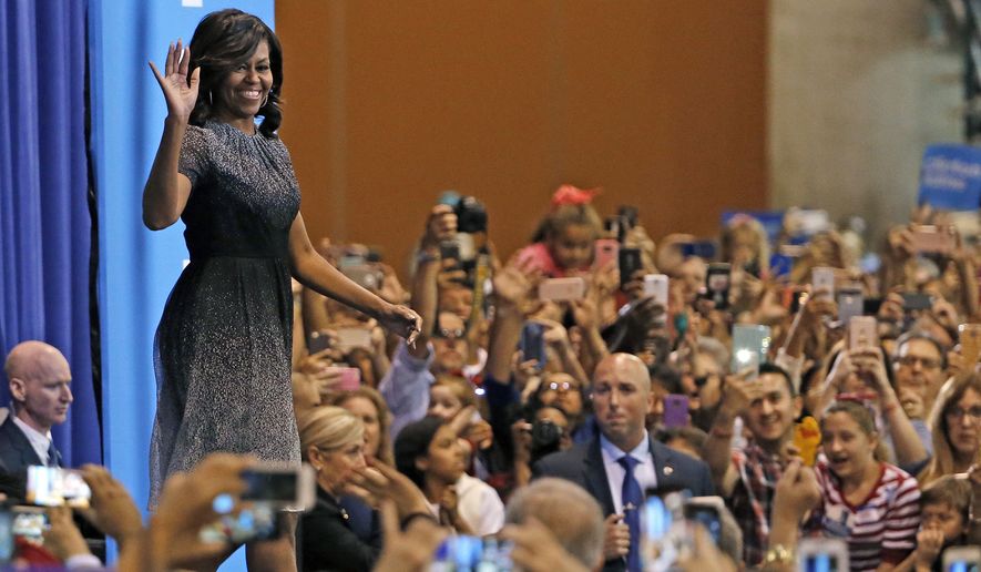 First lady Michelle Obama waves to supporters as she takes the stage at a campaign rally for Hillary Clinton on Oct. 20 in Phoenix. (Associated Press)