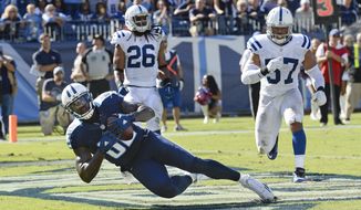 Tennessee Titans tight end Delanie Walker (82) catches a 7-yard touchdown pass ahead of Indianapolis Colts defenders Clayton Geathers (26) and Josh McNary (57) in the second half of an NFL football game Sunday, Oct. 23, 2016, in Nashville, Tenn. (AP Photo/Mark Zaleski)