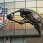 A statue of a rugby union player passing the ball stands outside of Twickenham stadium in London before an NFL football game between New York Giants and Los Angeles Rams, Sunday Oct. 23, 2016. (AP Photo/Matt Dunham)