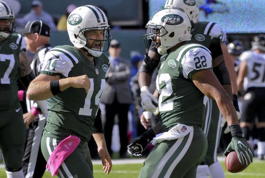 New York Jets quarterback Ryan Fitzpatrick (14) celebrates with running back Matt Forte (22) after Forte scored a touchdown against the Baltimore Ravens during the second quarter of an NFL football game, Sunday, Oct. 23, 2016, in East Rutherford, N.J. (AP Photo/Bill Kostroun)