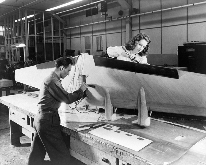 Flying Boat Construction Technicians at Langley installing flaps and wiring on a flying-boat model. April 24, 1946