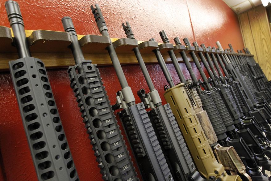 In this July 20, 2012, file photo, a row of different AR-15 style rifles are displayed for sale at the Firing-Line indoor range and gun shop in Aurora, Colo. (AP Photo/Alex Brandon, File) **FILE**