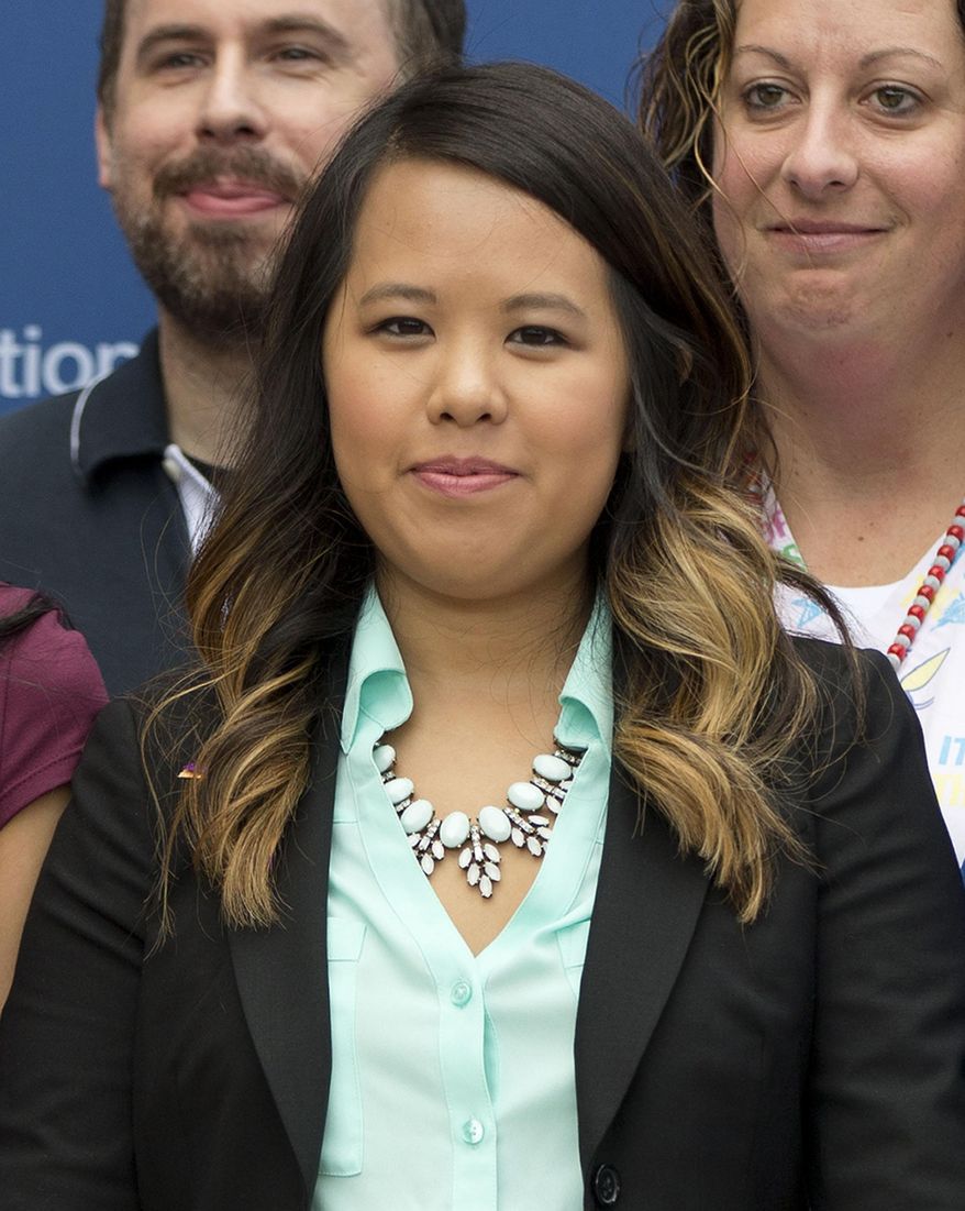FILE - In this Oct. 24, 2014 file photo, nurse Nina Pham poses for a photo at the National Institutes of Health (NIH) in Bethesda, Md. Pham, who contracted Ebola while caring for the first person in the U.S. diagnosed with the deadly disease, has settled a lawsuit against the parent company of the Dallas hospital where she worked. (AP Photo/Pablo Martinez Monsivais, File)