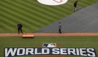 Members of the grounds crew prepare the field for batting practice for baseball&#39;s upcoming World Series between the Cleveland Indians and the Chicago Cubs, Monday, Oct. 24, 2016 in Cleveland. (AP Photo/David J. Phillip)