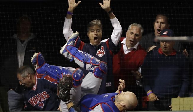 Chicago Cubs catcher David Ross class after catching a pop fly by Cleveland Indians&#x27; Lonnie Chisenhall during the first inning of Game 1 of the Major League Baseball World Series Tuesday, Oct. 25, 2016, in Cleveland. (AP Photo/David J. Phillip)