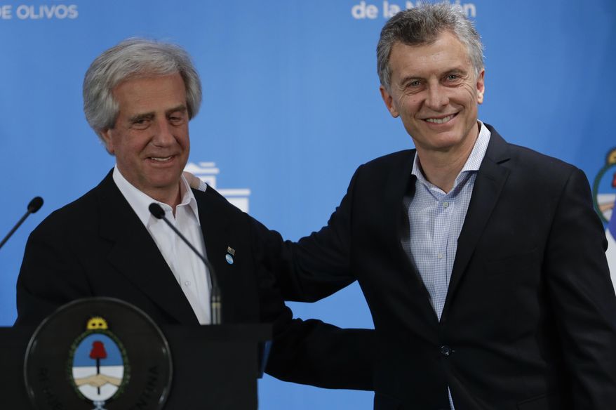 Uruguayan President Tabare Vazquez, left, and Argentina's President Mauricio Macri, embrace after a joint press conference at the presidential residence in Olivos, a northern suburb of Buenos Aires, Argentina, Monday, Oct. 24, 2016. (AP Photo/Natacha Pisarenko)